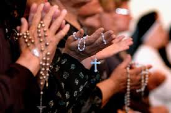 People Praying and Holding Rosaries People Praying and Holding Rosaries